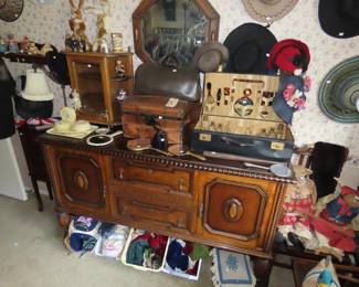 Antique sideboard, vintage hats and dolls clothes.