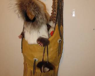 Vintage papoose carrier and Eskimo figures.