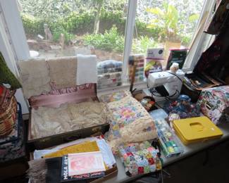 Sewing machine, vintage doilies, rossette hand made quilt, sewing notions.
