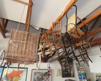 Antique doll chairs and carriages and strollers.
