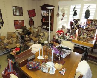 Room of dolls and bears and antique shelves, dining set and corner curio.