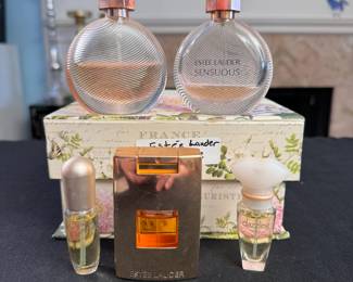 Grouping of Estee Lauder partially used perfume bottles