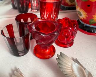 Group of red shot glasses and candle holders