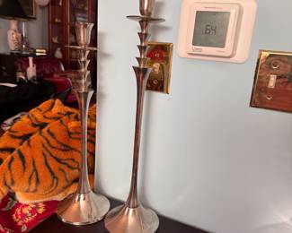 Two tall silver metal candlestick holders, tallest is 20"