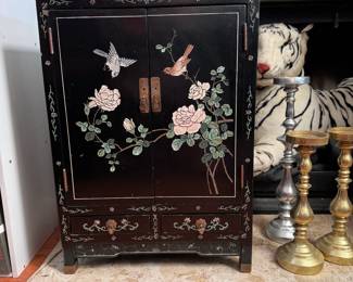 Oriental cupboard with two drawers, birds resting on pale pink flowers, some chips and wear is seen 26"H x 18"W x 9"D