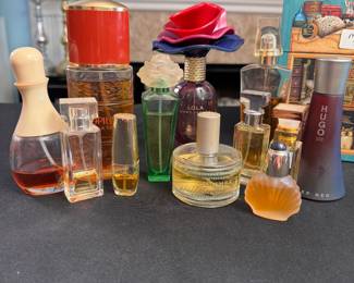 Grouping of miscellaneous partially-used perfume bottles