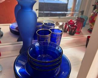 Group of blue plates, cups, bowls and frosted vase