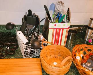 Longaberger basket, utensils, iron trivets, large cutting board