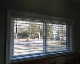 Interior faux wood white blinds.