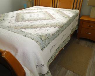 Depending on the height of the bed, either a queen comforter or bedspread