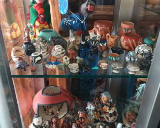 Small native American pottery pieces and Storyteller figures