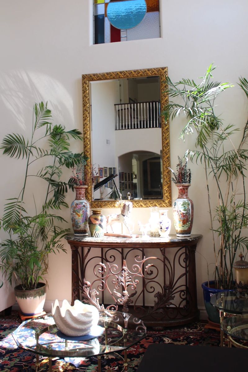 This mirror is very heavy and large - about 48x68, the console below is made out of wrought iron and marble top, the plants on the side are real and gorgeous