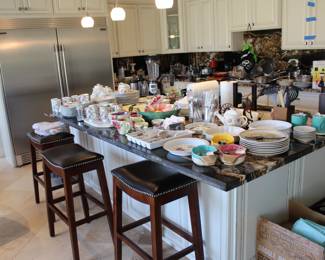 Kitchen view with bar stools and all type of kitchen utilities, small appliances and goodies