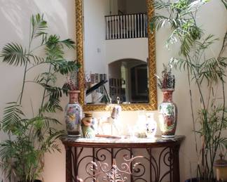 This mirror is very heavy and large - about 48x68, the console below is made out of wrought iron and marble top, the plants on the side are real and gorgeous