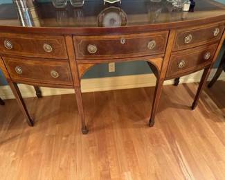 $1800. Online purchase available starting at 9 am sharp until 4pm Thursday.  Click message icon for instructions.    Baker "Historic Charleston" Mahogany sideboard.  Bow front case with double-banded top. Center drawer is felt lined for flatware storage. 38.5"h X 62"w X 26"d.  Original price $4,200.   This is not onsite.