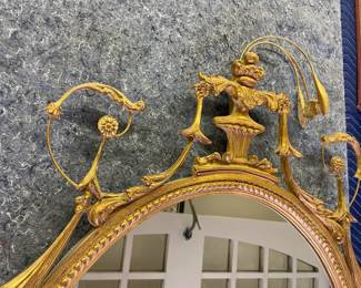 Close up of intricate detail on the gold framed mirror