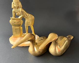 Egyptian figure on marble base. Two brass ducks.
