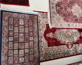 Assortment of new rugs.