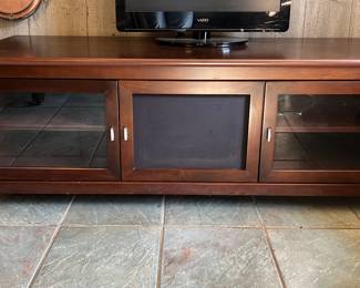 Wood entertainment center with glass doors