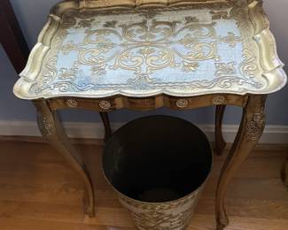 Gilded tray table and trash can.
