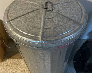 Large galvanized metal trash can.