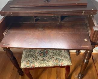 Small pull-out desk and stool.