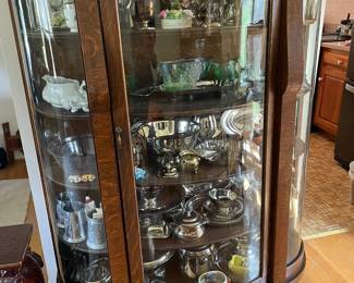 Breakfront with assorted silverplate, pewter and glassware.