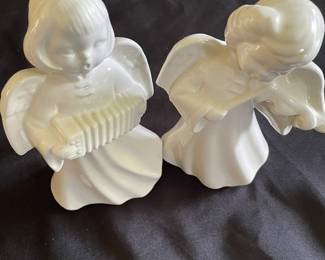Vintage ceramic angels playing music.