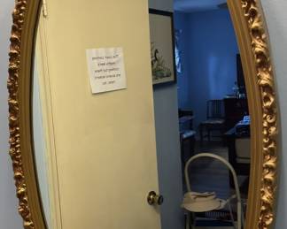 Oval gilded mirror.