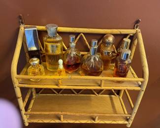 Small wicker shelf and perfume bottles.