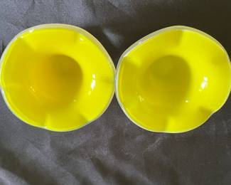 Pair of yellow candle-stick holders.