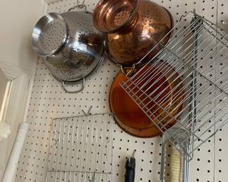 Colanders and metal trays.