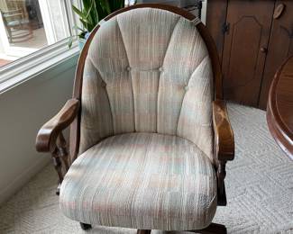 closeup of chairs that go with dining table, on rollers