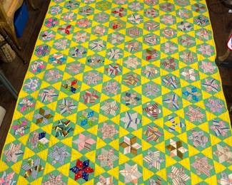 Vibrant. Hand stitched in great condition. Appears unused and stored. No filler. Good for spring and summer. Star quilt.