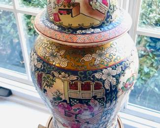Pair of Asian rose medallion painted urns with gilt foo dog lids