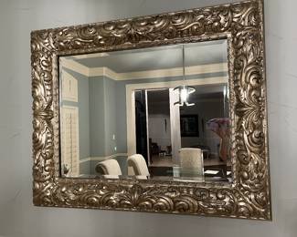 Very large beveled mirror with gold swirl frame