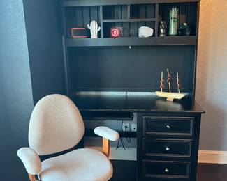 Black computer desk. And there are two desk chairs available.