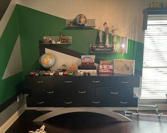 Custom built chest of drawers, games and puzzles are on the top.