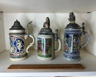 C46 -  Left to Right. $10 Stein has crack. $15 Stein with Frier Lid. $15 Stein with Owl Lid. 