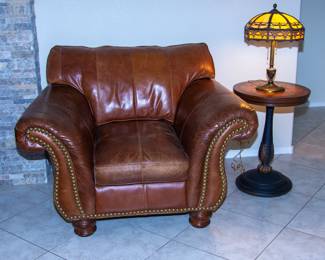 Antique leather chair and table with decorative antique lamp
