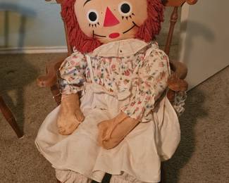Raggedy Ann in wooden rocker. The doll is 42" tall.