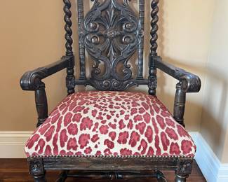 Foyer:  This is one of the two separately priced Baroque-style chairs.  They look like small thrones.  Notice the turned knob finials, twisted stiles and twisted front legs.  Each antique Baroque armchair is carved walnut with raised velvet upholstery.  The next photo provides a side view.