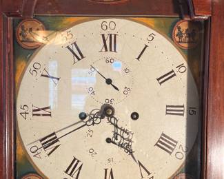 Foyer:  The hood of the tall case clock has a metal dial face with a painted floral bouquet at the top and different scenes in each corner.  Notice the large Roman numerals and the smaller Arabic numerals used in the second hand and calendar dials.