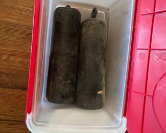 Foyer:  These are the heavy weights that belong in the trunk of the antique tall case clock.  An antique pendulum (lead covered brass) is nearby. 