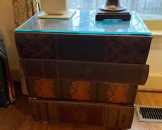 #47	Table 	Side Table (looks like 4 books) w/glass top w/design on top - 20x14x21.5 as is	 $75.00 			
