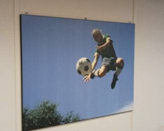 Large photograph of a person playing soccer