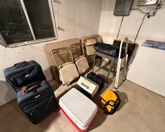 Coolers, luggage, folding tables and chairs. Air mattress, metal cart.