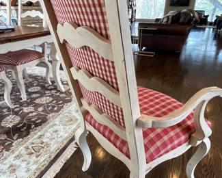 French country dining table.  72L x 44w - shown with one 20” leaf installed. One additional leaf available. 8 cream colored side chairs, 2 captain armchairs with coordinating French red fabric. 
