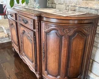 PRESALE AVAILABLE! Antique French Country demilune buffet / sideboard – 40.25h x 22d x 83w. Pulled from a Lake Geneva, WI estate. Original key included. Single large interior shelf holds large hostess items. Dovetail drawers. Curved side cabinets with shelves. Beautiful hardware.