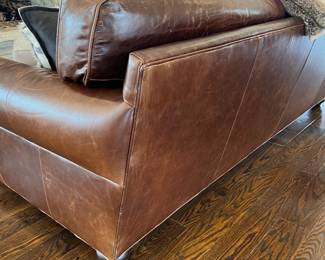 Restoration Hardware leather sofa with bun feet. 2 cushions, extra deep. Front left bottom corner has very slight scuffing. 97w x 48d at arm x 36h Excellent, barely used condition, purchased in May 2023.